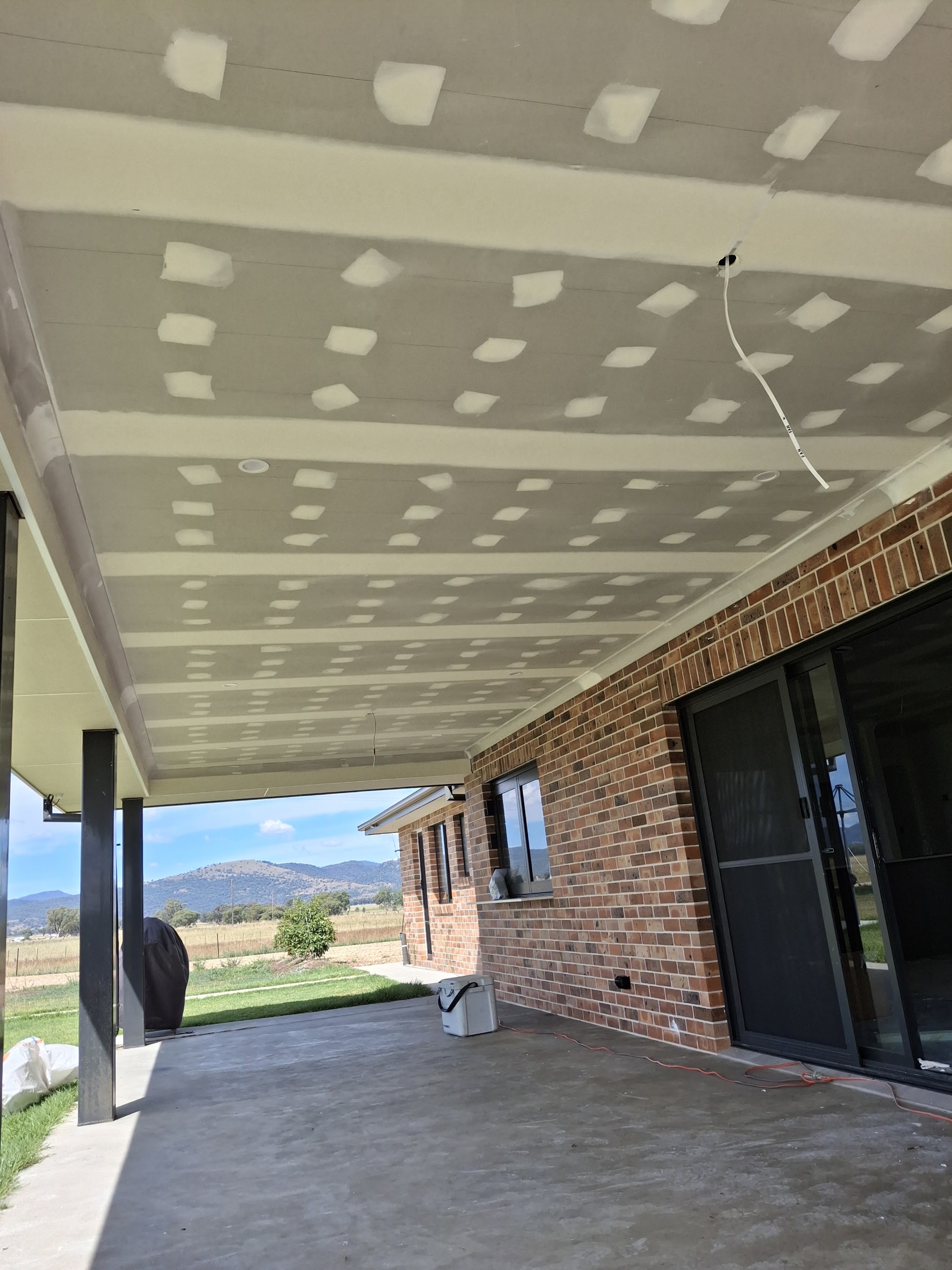 A finished alfresco ceiling set and sanded on a brick home near Quirindi, looking out across the Liverpool Plains to the hills