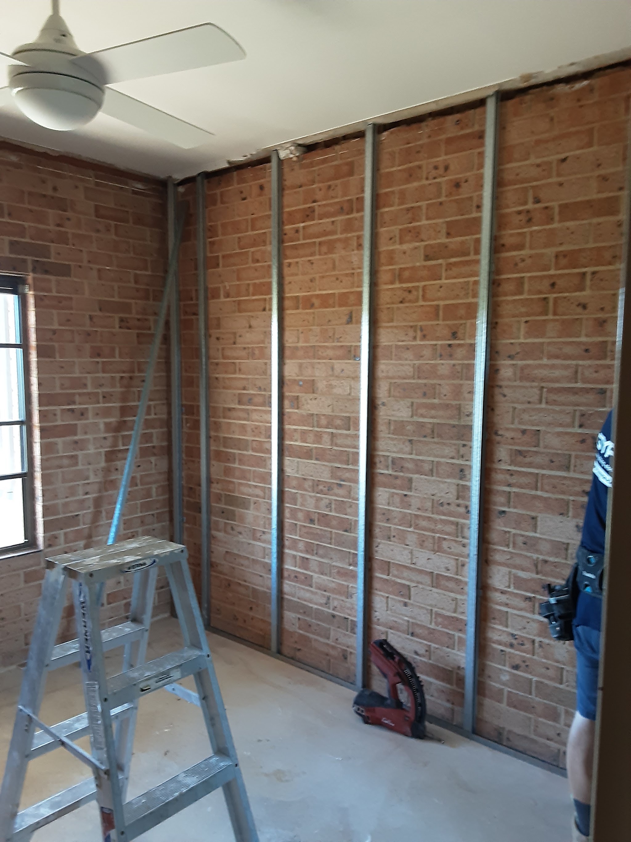 Furring channel battened over an existing internal brick wall ready to be sheeted